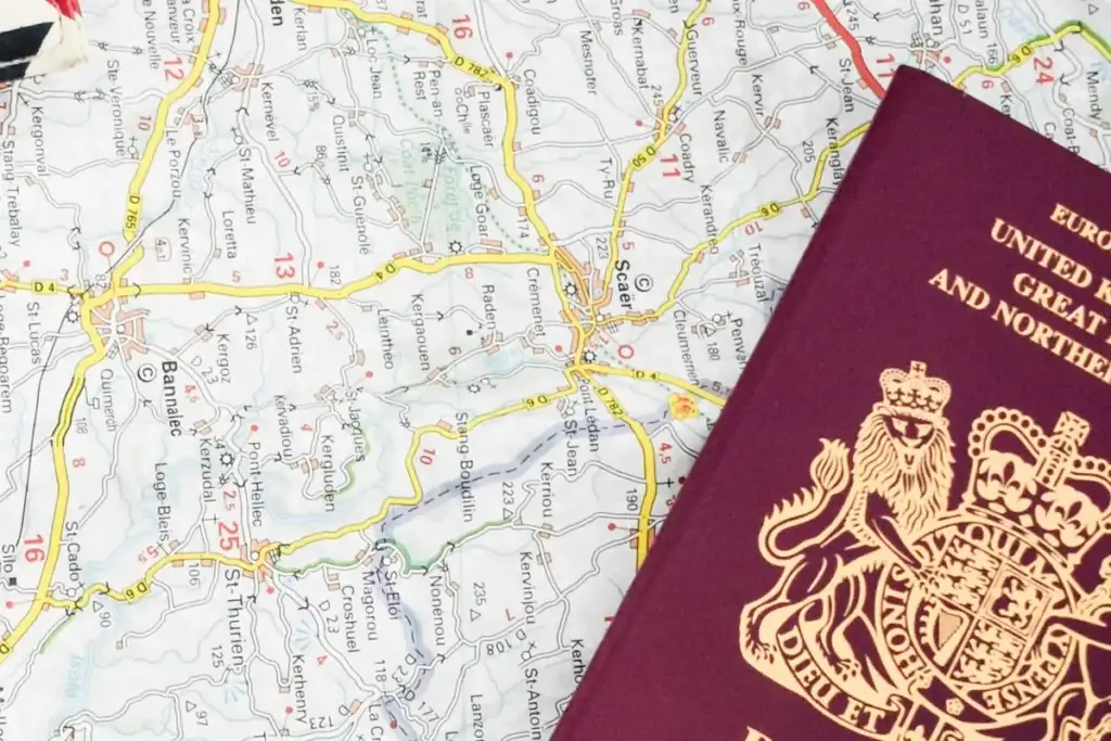 UK passport lying on a road map