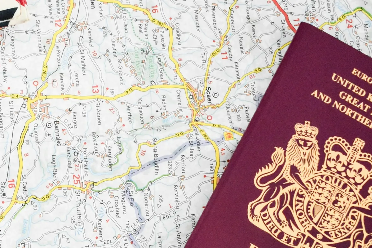 UK passport lying on a road map